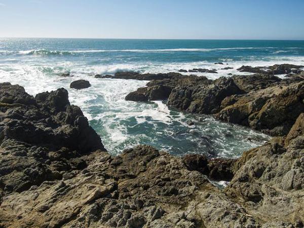Waves crashing against a rocky bluff